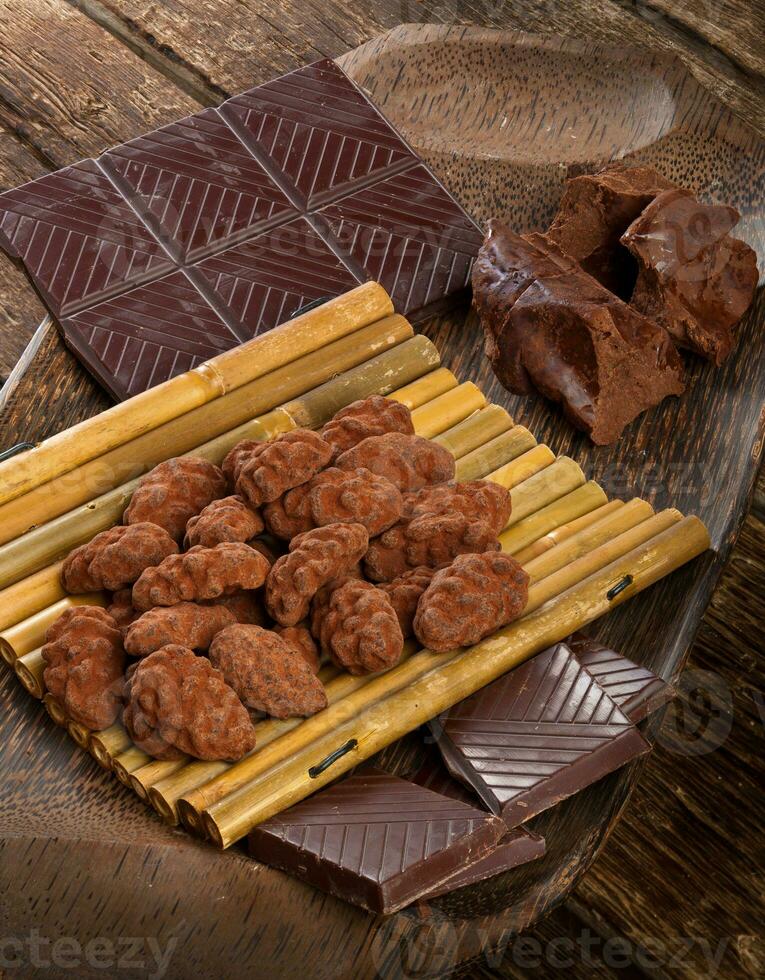 Cocoa beans, dark chocolate and chocolate truffles photo