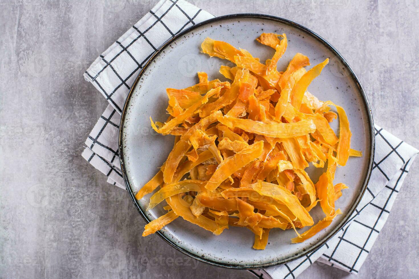 Close up of appetizing vegetarian dessert pumpkin chips on a plate on the table top view photo