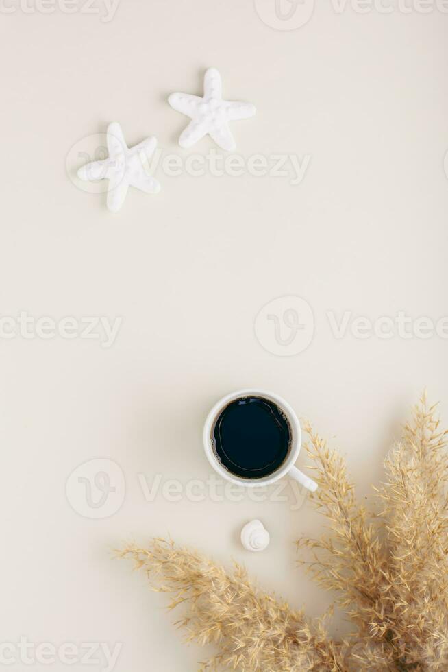 Summer vacation and relaxation concept starfish, shells and a cup of coffee on a pastel vertical photo