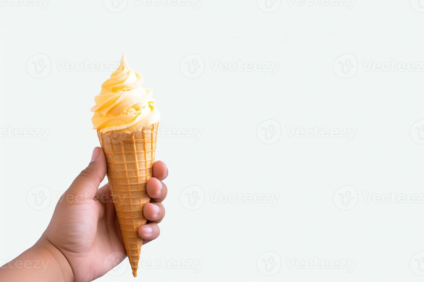 Hand holding delicious mango ice cream in a crispy waffle cone with copy space. photo