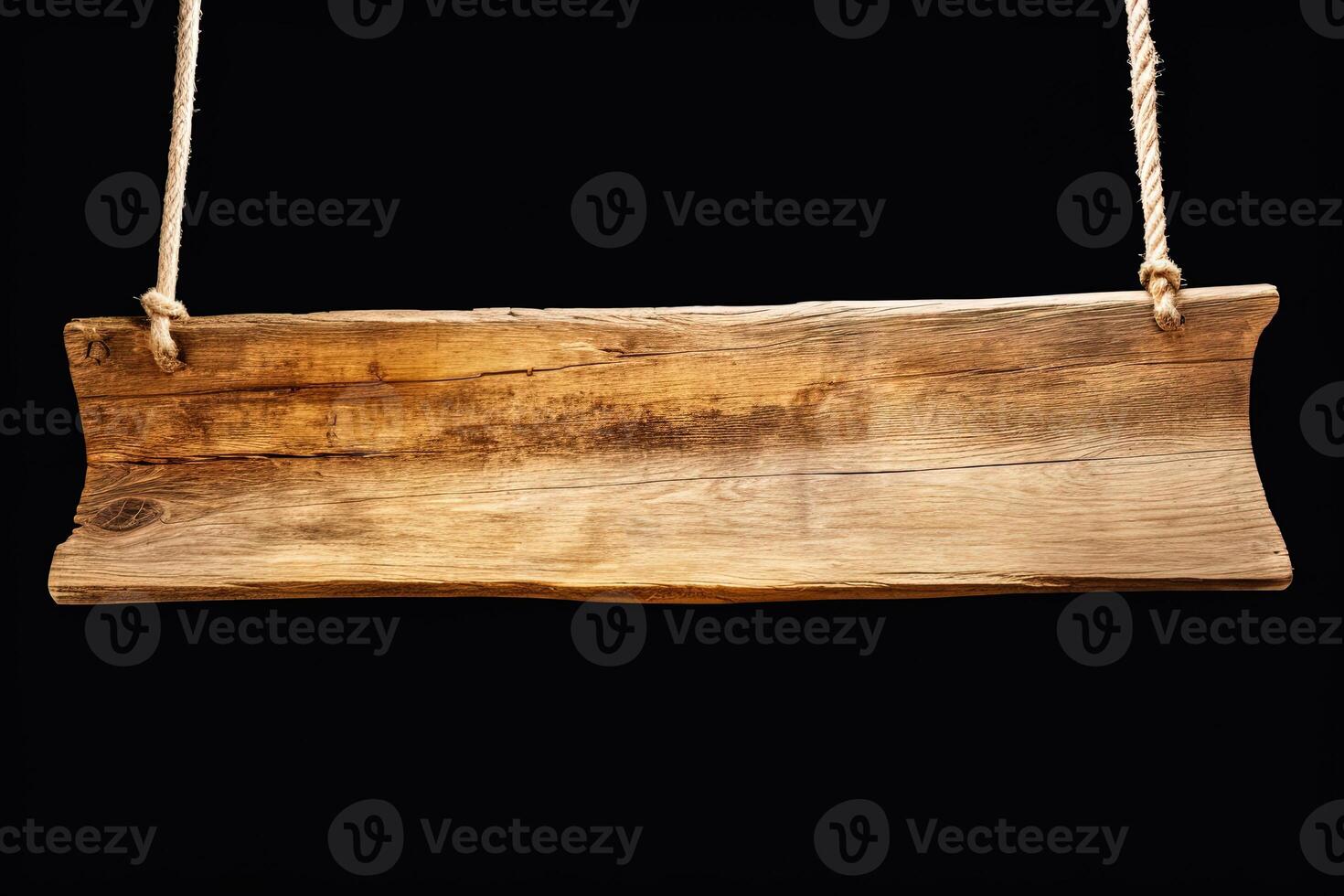 Wooden sign plain hanging from rope isolated on black background. photo