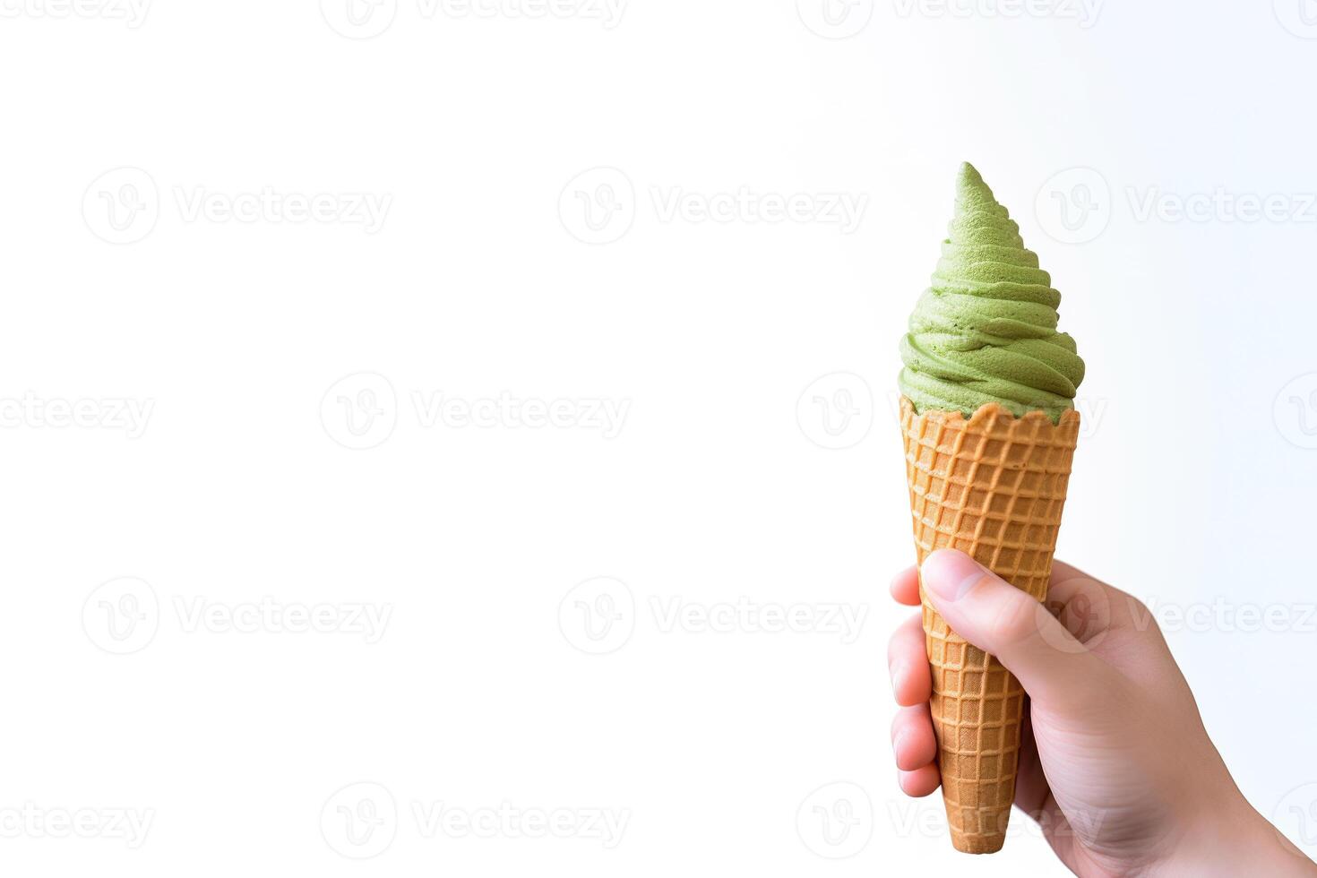 Hand holding delicious matcha ice cream in a crispy waffle cone with copy space. photo