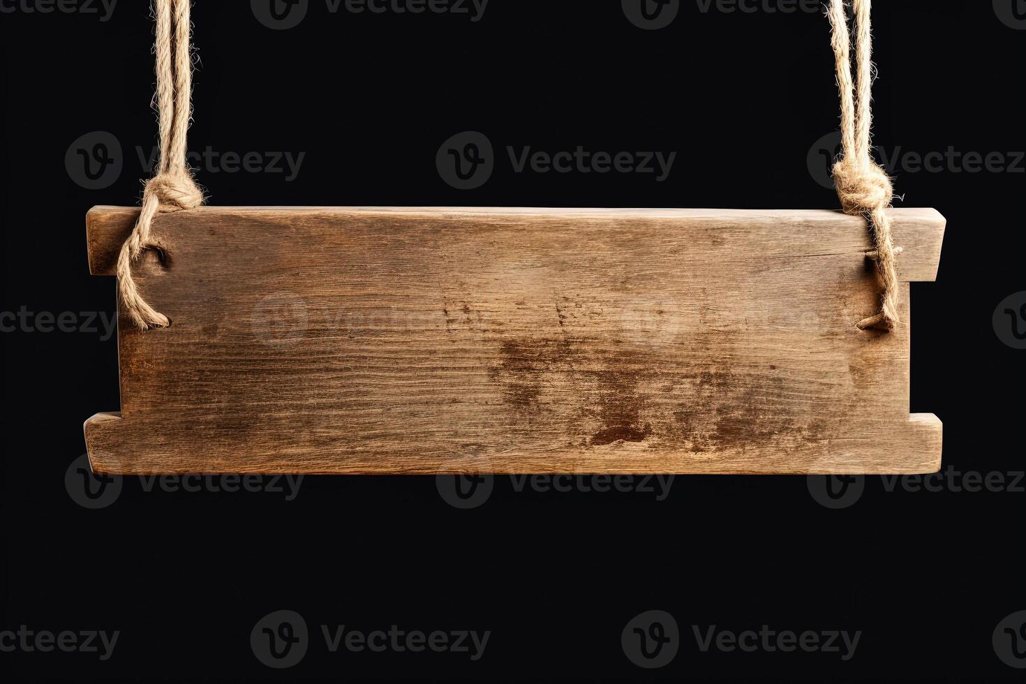 Wooden sign plain hanging from rope isolated on black background. photo