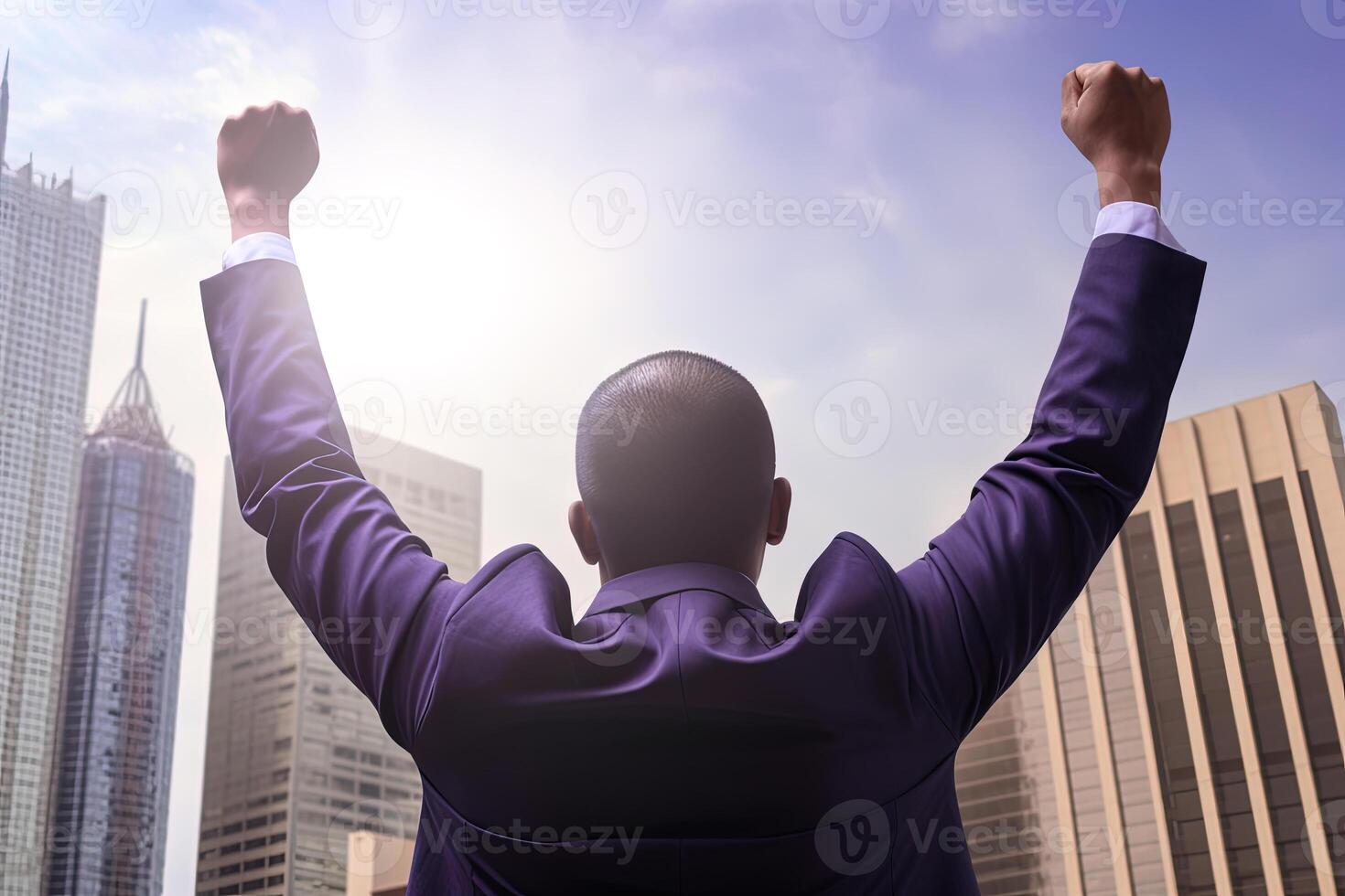 Successful businessman raising hand and expressing positivity while standing against skyscrapers background. photo