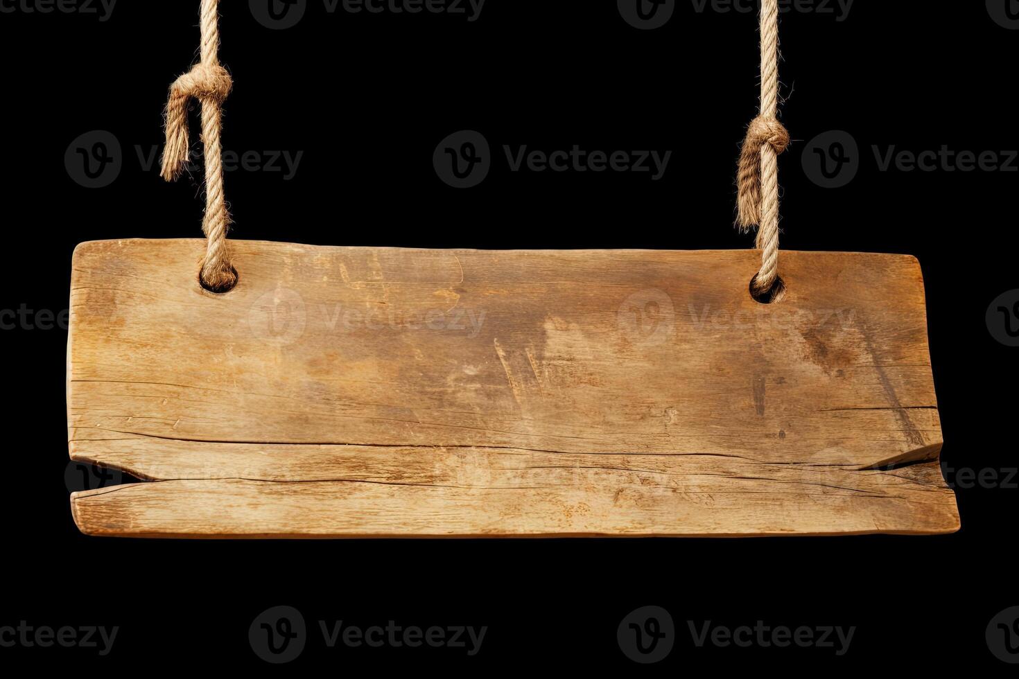 Wooden sign plain hanging from rope isolated on black background. photo