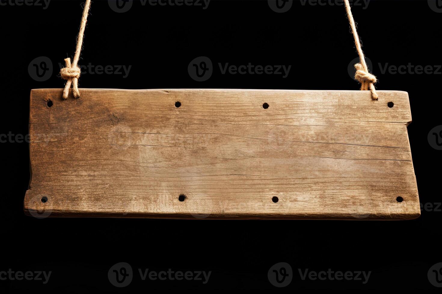 Wooden sign plain hanging from rope isolated on black background. photo