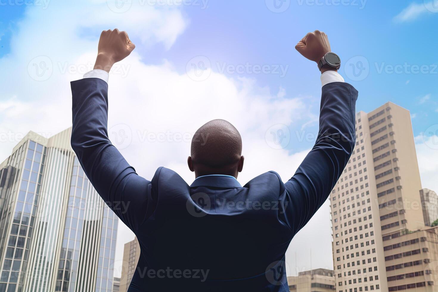 Successful businessman raising hand and expressing positivity while standing against skyscrapers background. photo