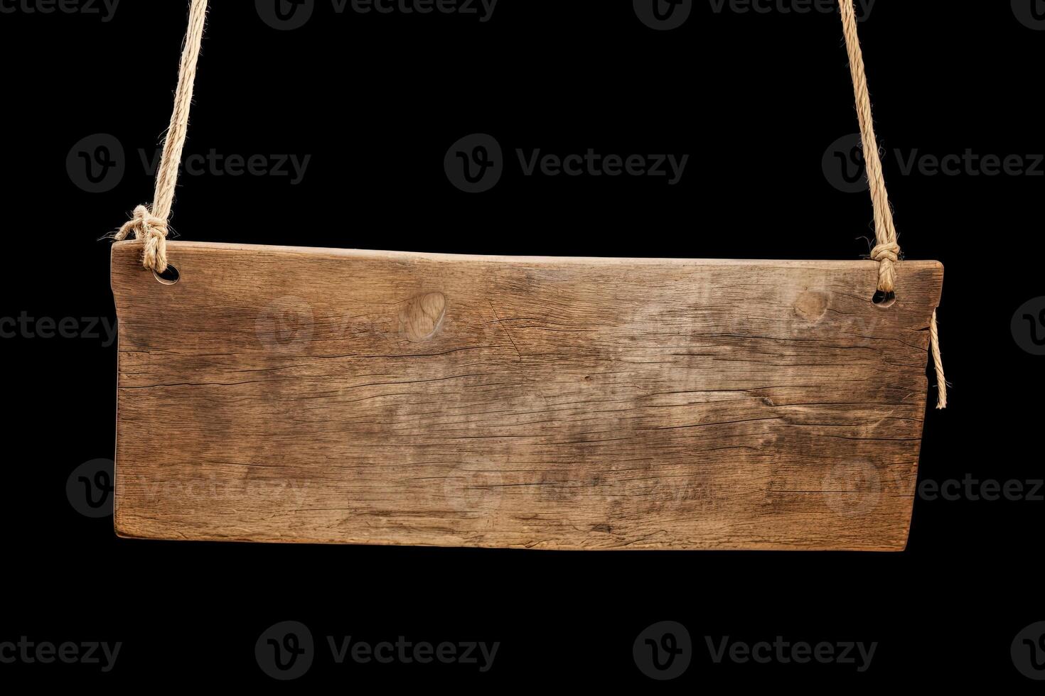 Wooden sign plain hanging from rope isolated on black background. photo