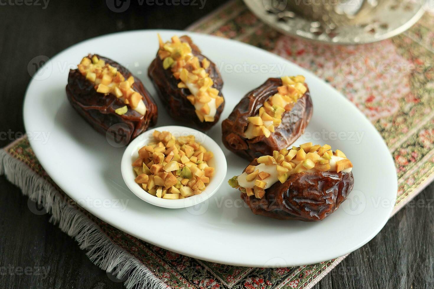 Stuffed Dates Fruit with Cream and Chopped Pistachio Nut photo