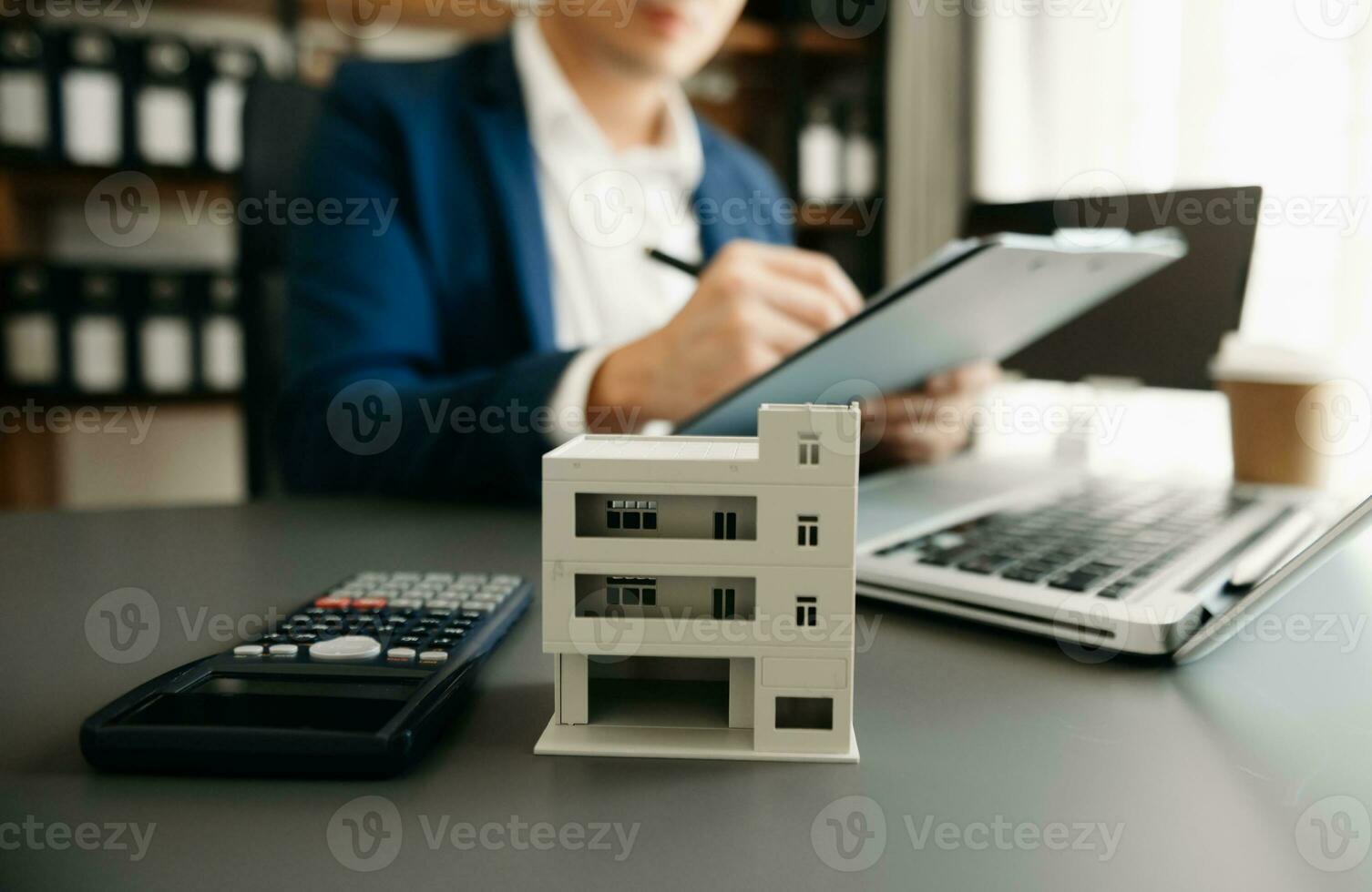 Signing a contract. Client and broker agent, lease agreement, successful deal and  Young business sitting at the desk in office photo