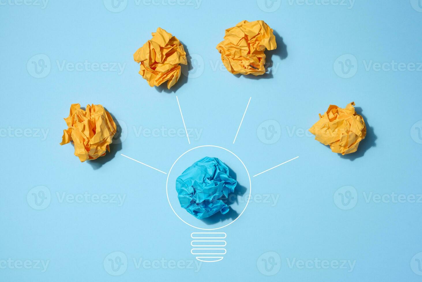 The concept of inspiration with new ideas, the search for creative solutions, crumpled sheets of paper in the form of balls on a blue background photo
