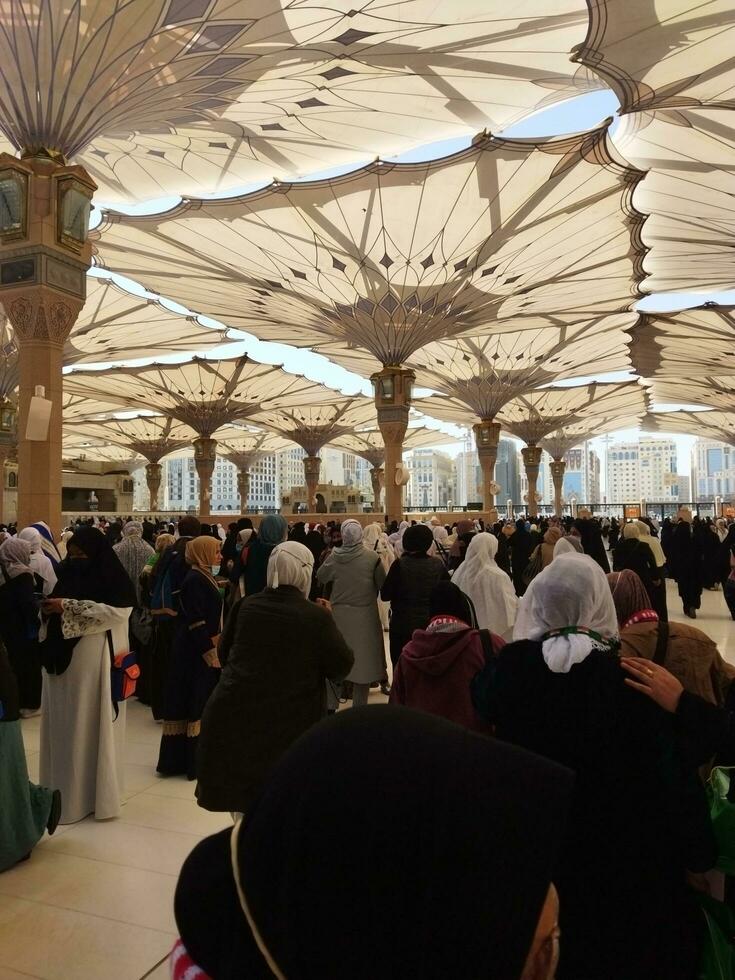 Makkah, Saudi Arabia, February 2022 - Many women are take shelter under the beautiful and iconic tent. photo