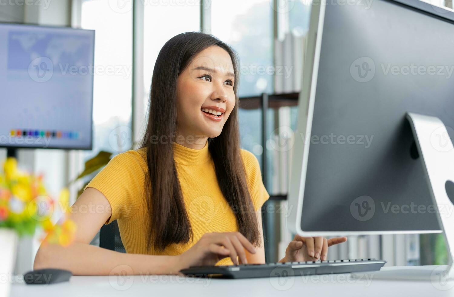 Portrait happy young programmer Asian woman work at start up technology office and using computer for coding application program and fully creative. Concept of smart entrepreneur woman working. photo