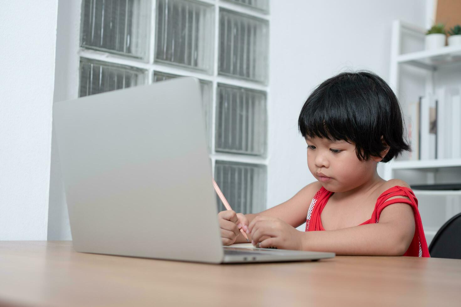 Happy Asian girl student online learning class from a computer with a teacher, online education is a technology for social distance in a new normal lifestyle, Concept of home school and tutor photo