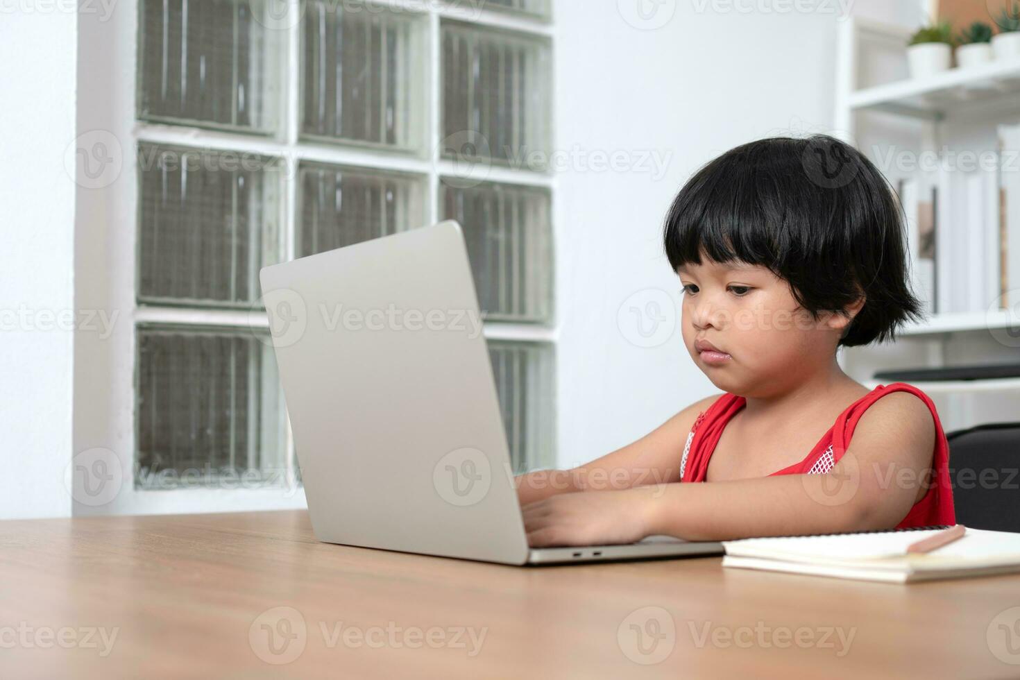 Happy Asian girl student online learning class from a computer with a teacher, online education is a technology for social distance in a new normal lifestyle, Concept of home school and tutor photo