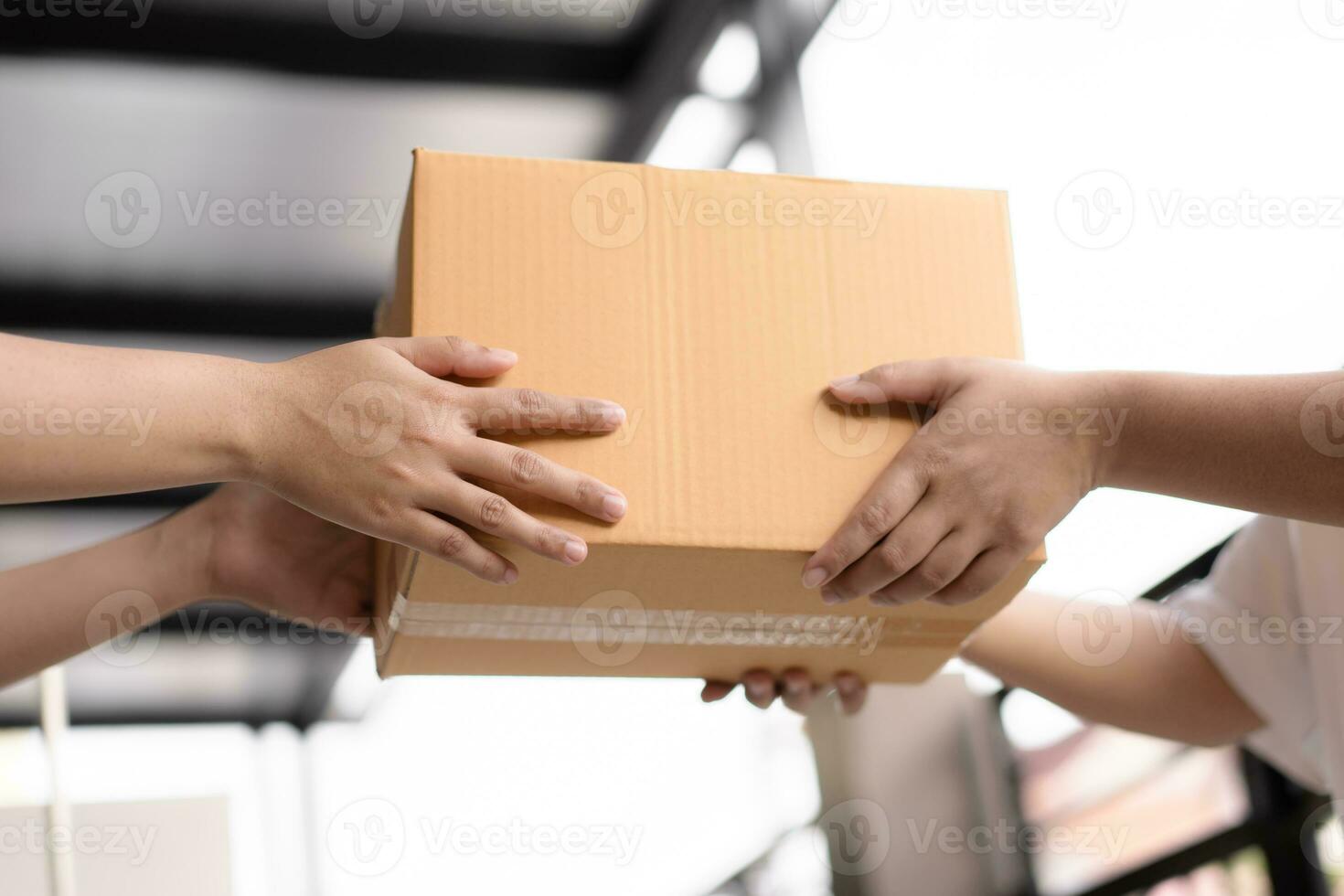 Postal service sending paper cardboard box to customer in front of a house outdoor. Shipping service arrival and send to customer address. photo