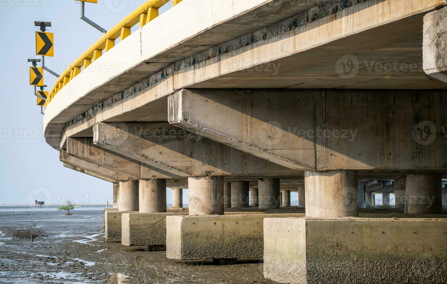 Structure of reinforced concrete bridge along the sea. Bottom view of concrete bridge. Concrete bridge engineering construction. Modern cement bridge with strong column architecture. Infrastructure. photo