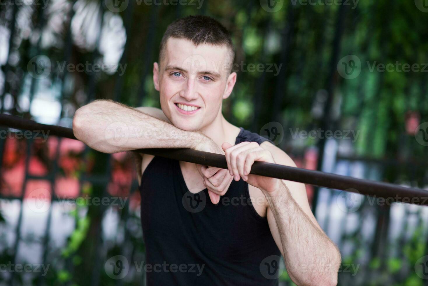 Athletic Man doing exercise with bar photo