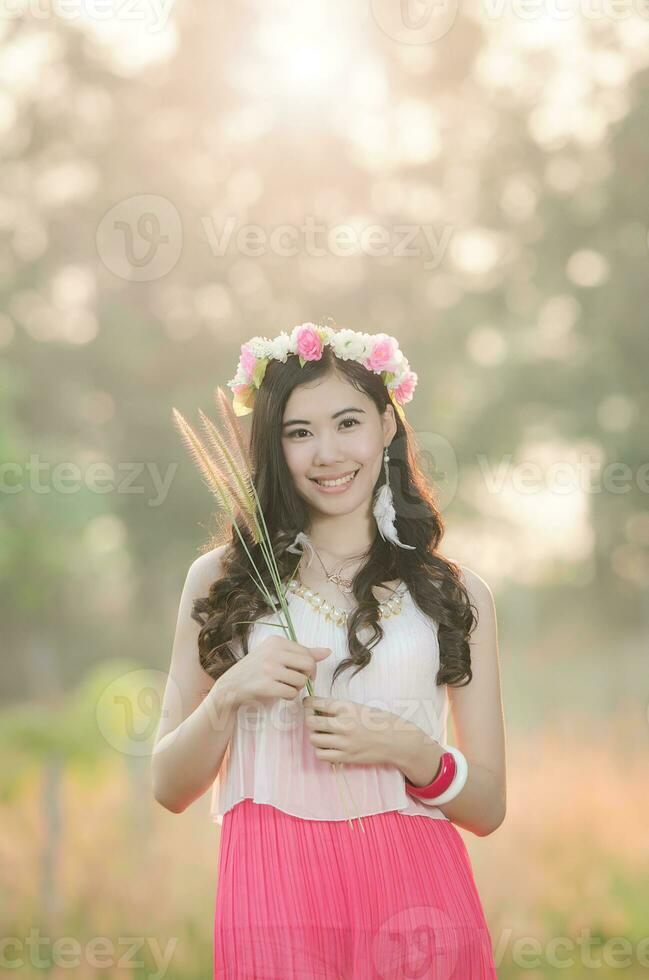 Pretty girl smiles in spring flower grass field 2 photo