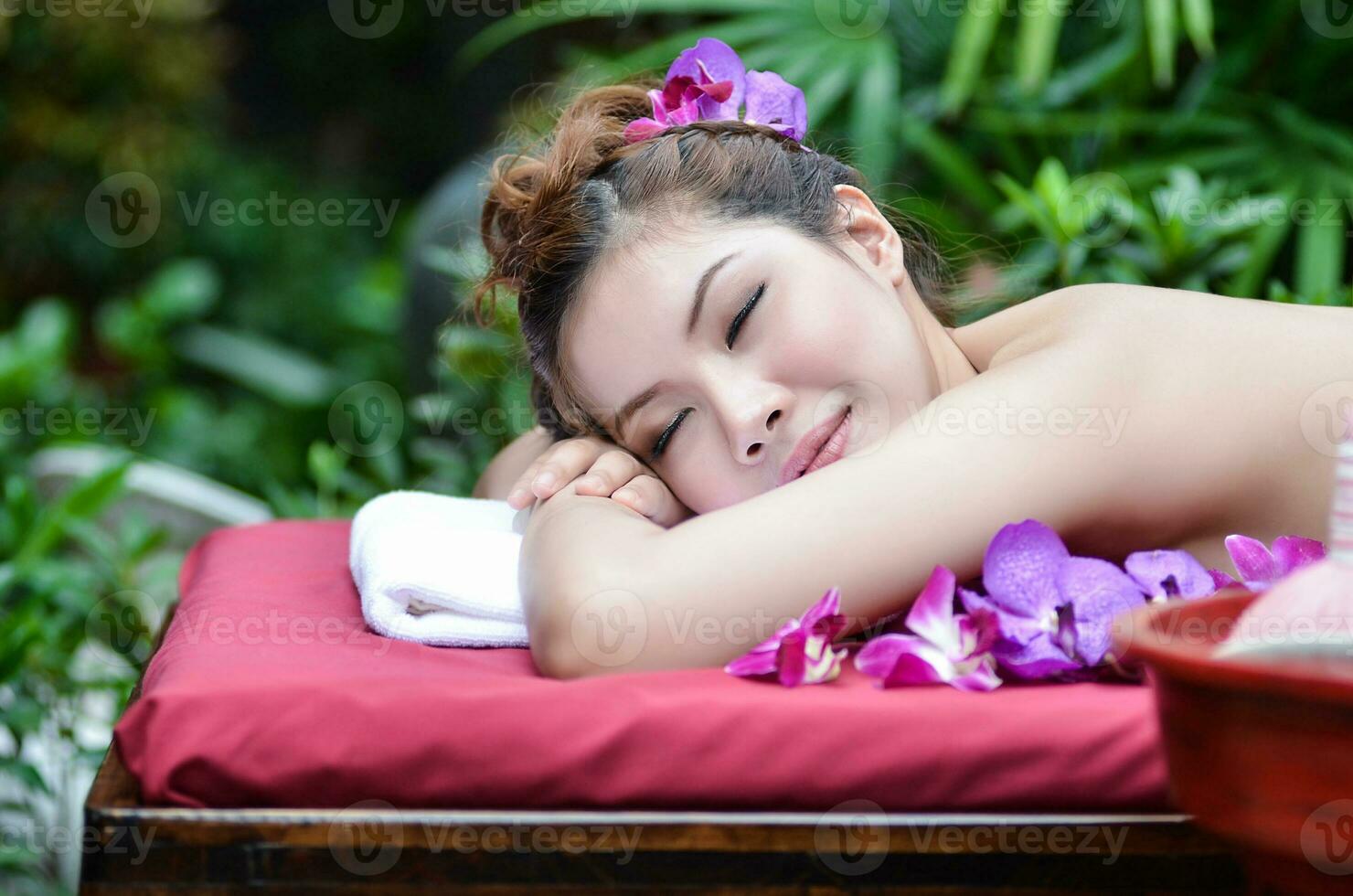 Beautiful Asian girl doing spa massage photo