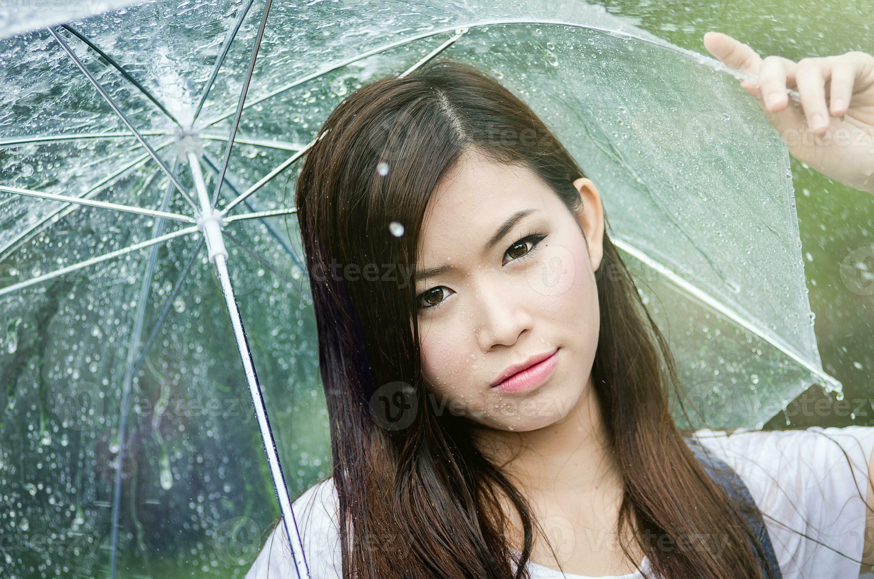 Beautiful girl is standing with umbrella among a rain 4 23371062 Stock Photo at Vecteezy
