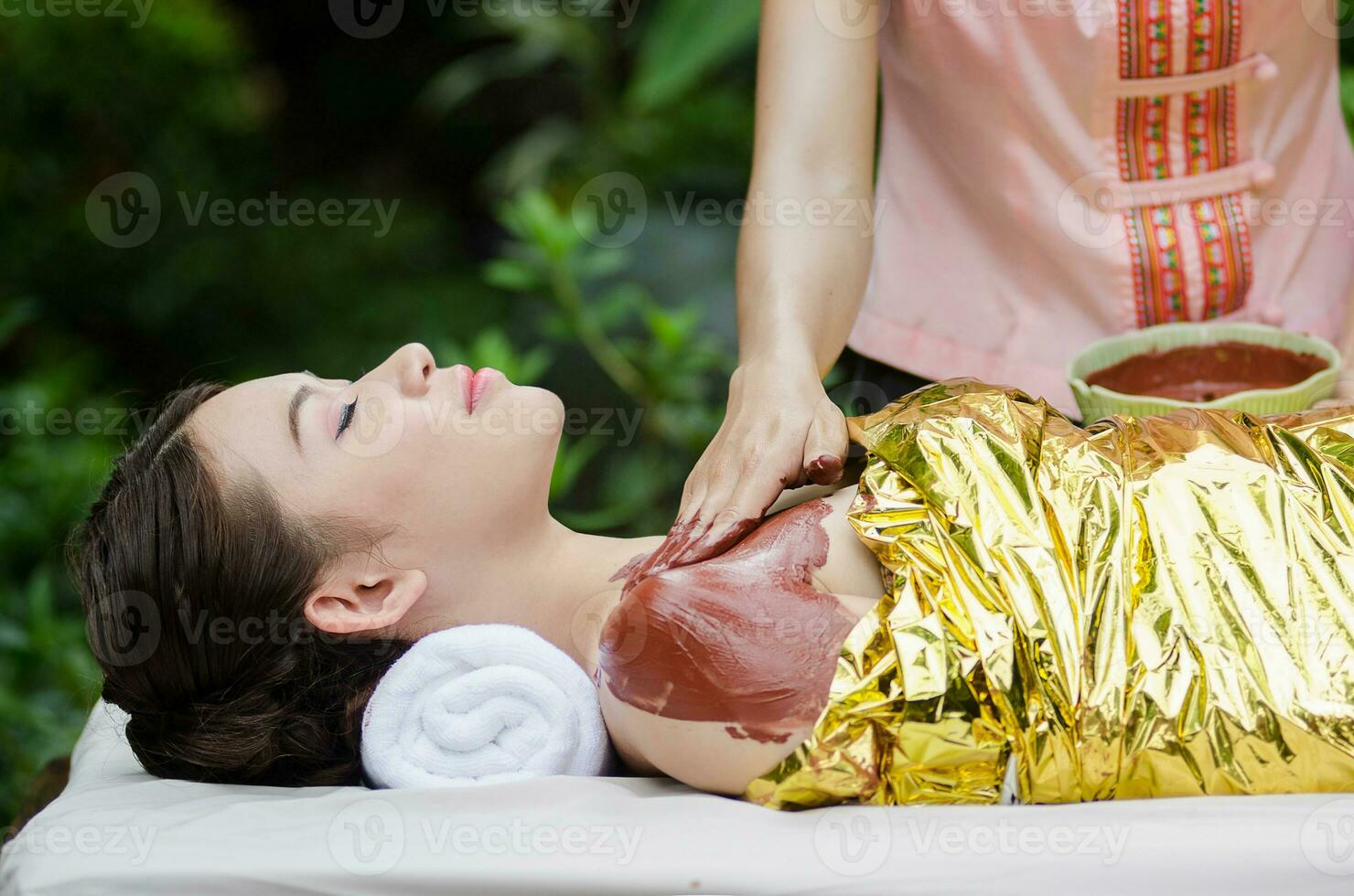 Beautiful Asian woman doing spa massage photo