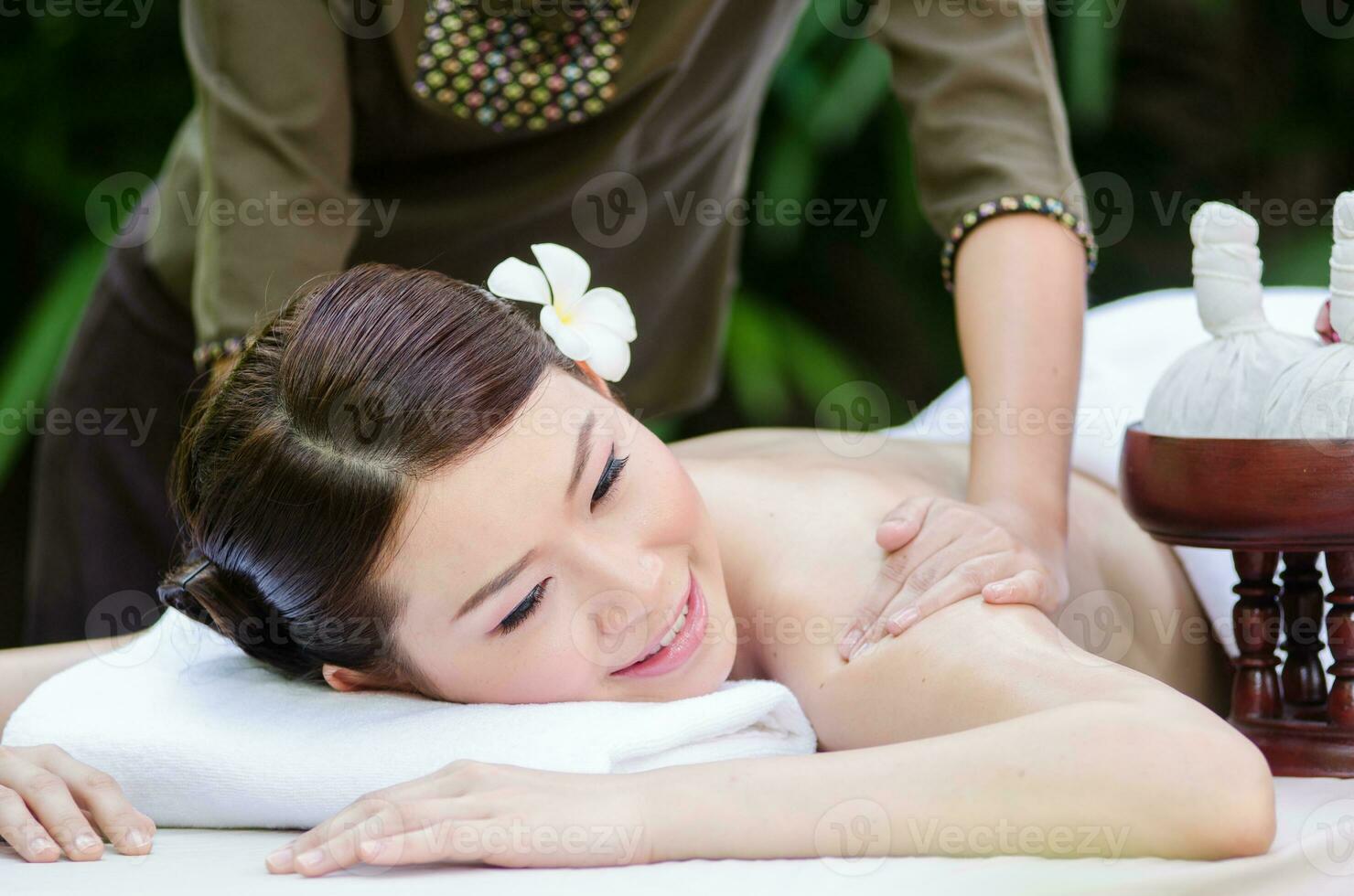 Beautiful Asian woman doing spa massage photo