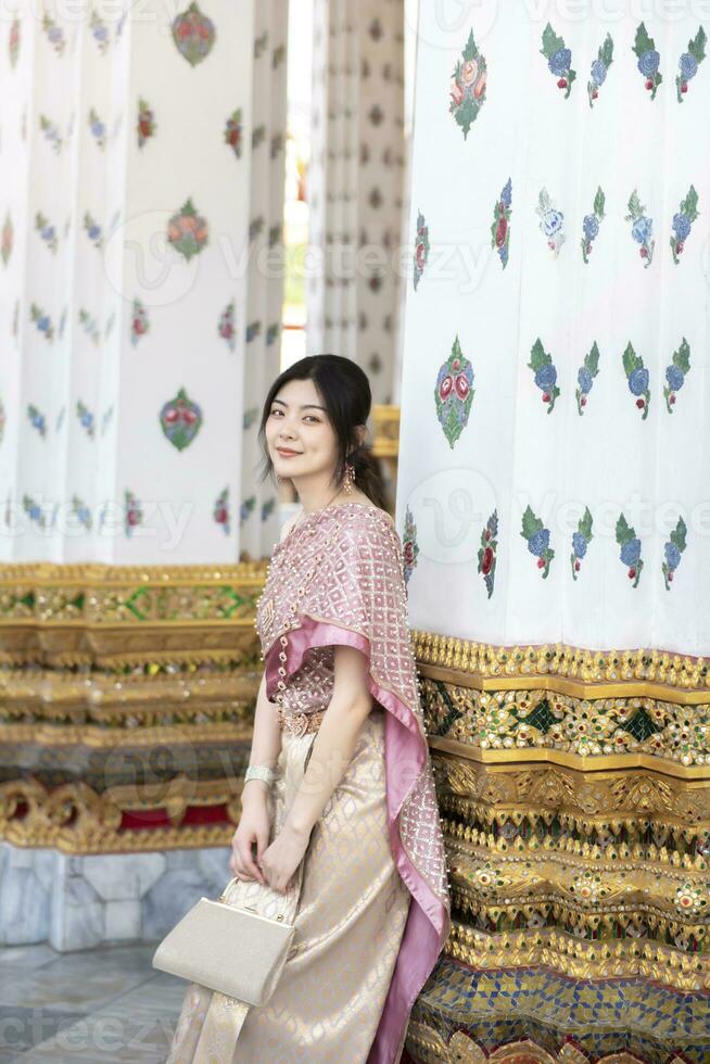 Beautiful Asian girl in Thai traditional costume at temple photo