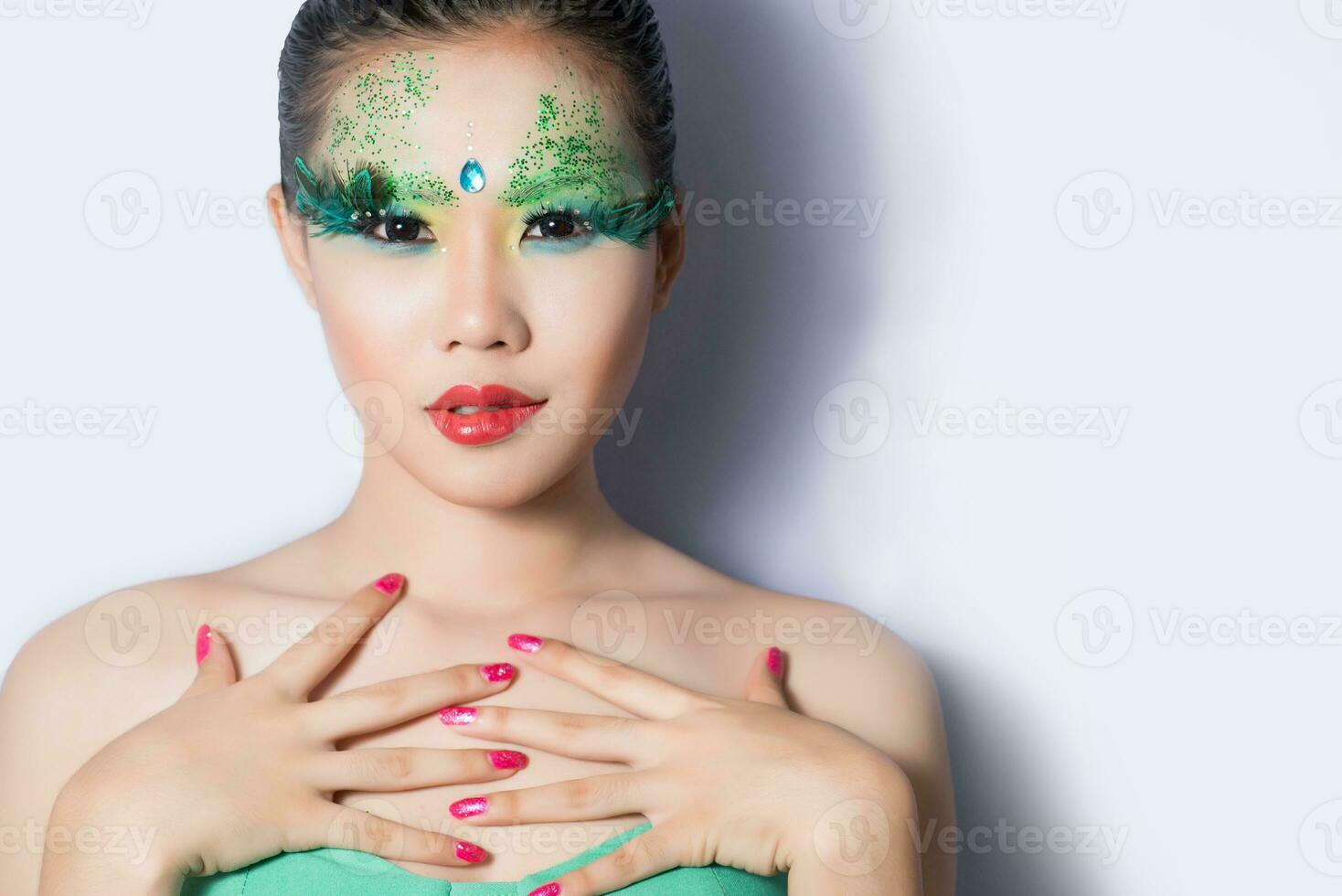 beautiful women with perfect art make up and long false eyelashes made from feathers photo