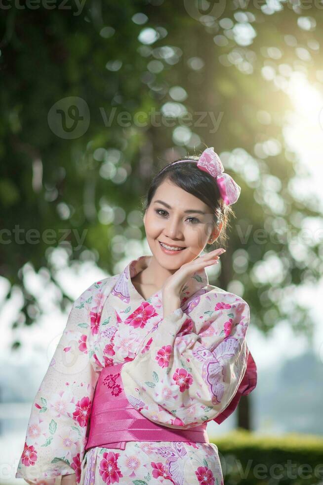 Beautiful young woman wearing japanese traditional Yukata photo