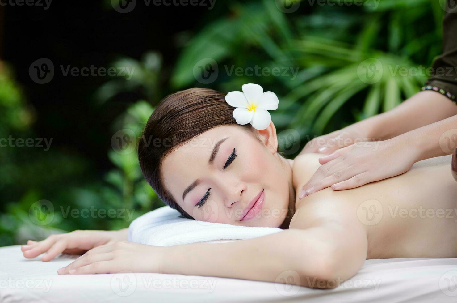 Beautiful Asian woman doing spa massage photo