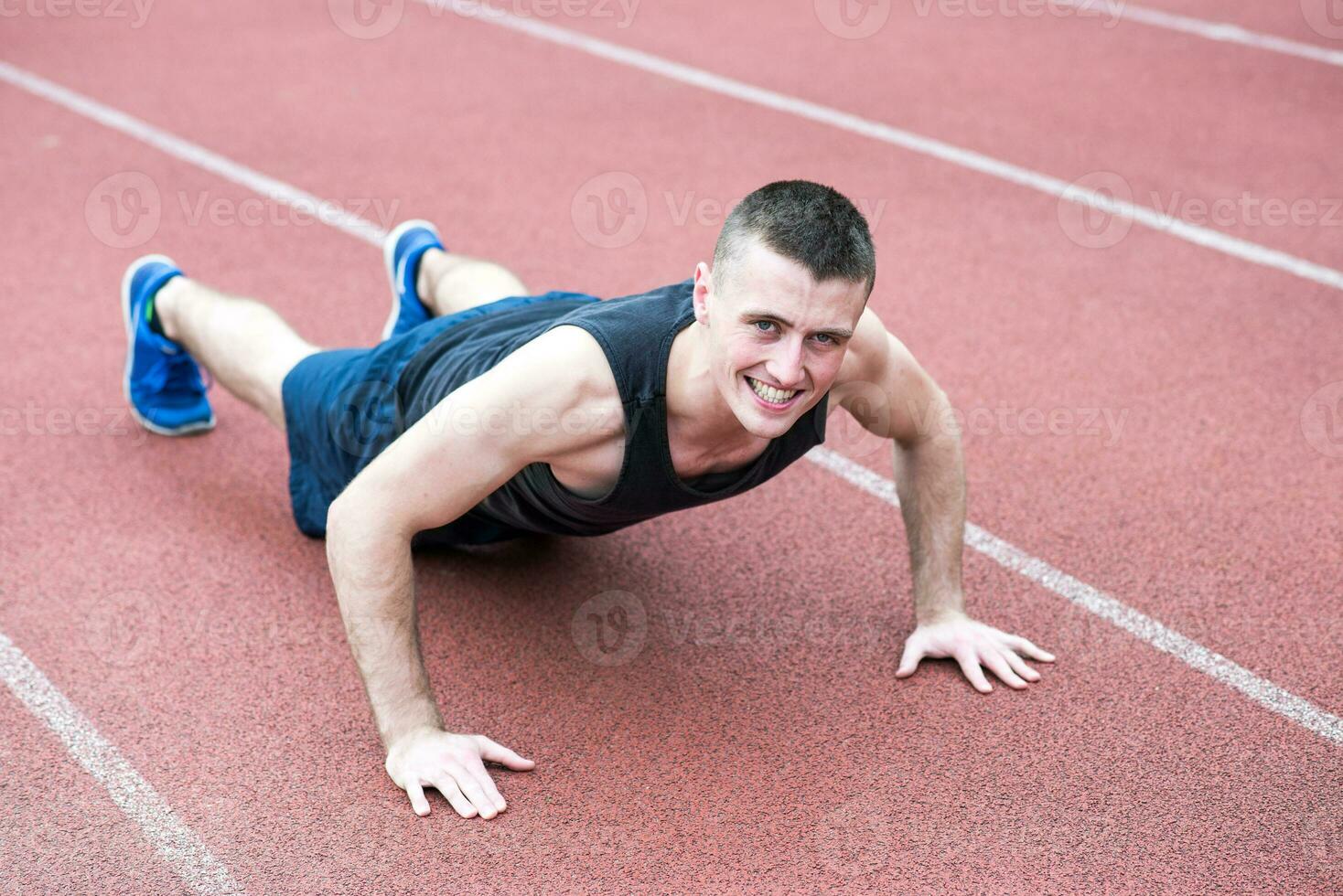 Handsome fit man exercising push up photo