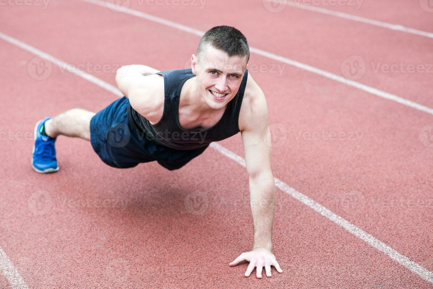 Handsome fit man exercising push up one hand photo