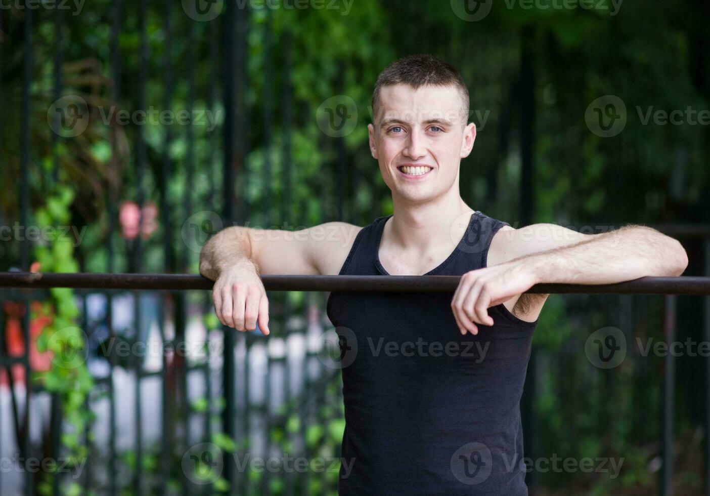 Athletic Man doing exercise with bar photo