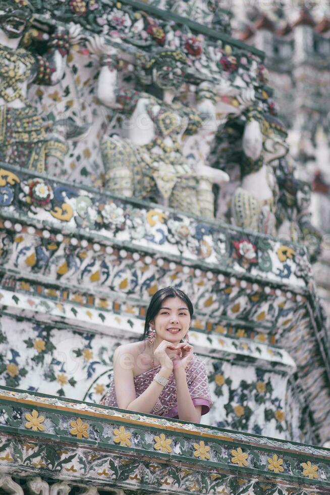 Beautiful Asian girl in Thai traditional costume at temple photo