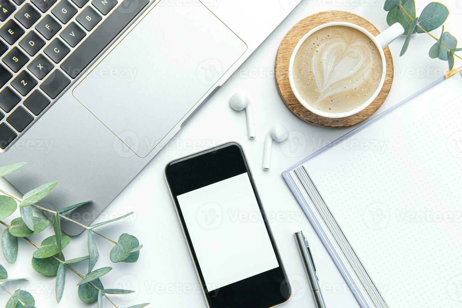 Office desk table with laptop, supplies and coffee cup photo