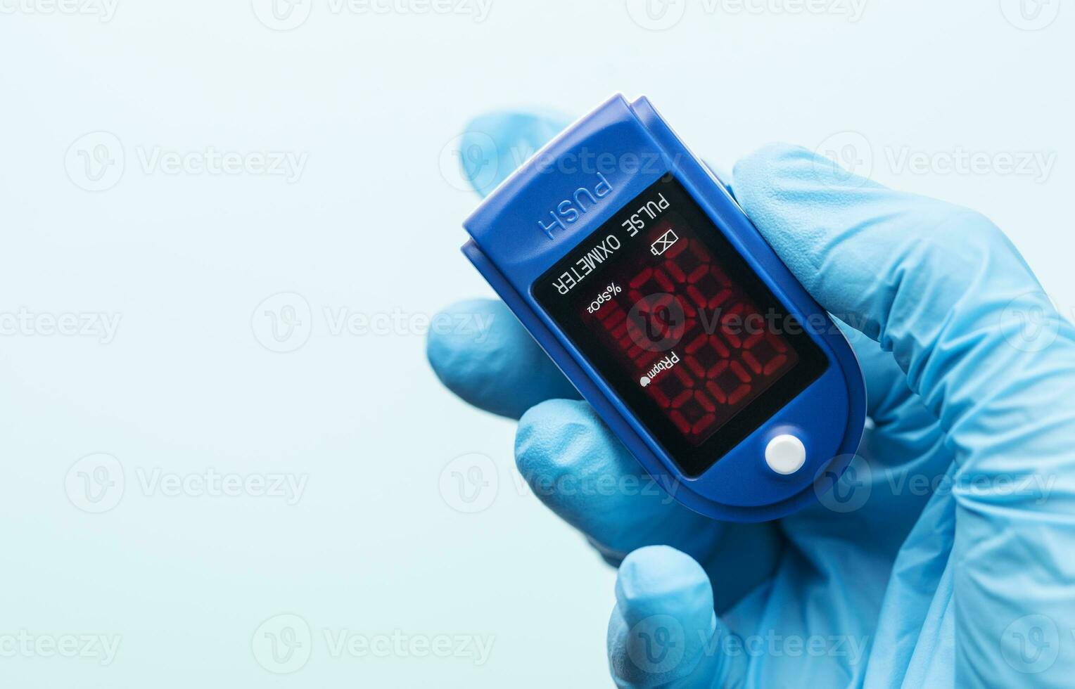 Pulse oximeter in doctor hand photo