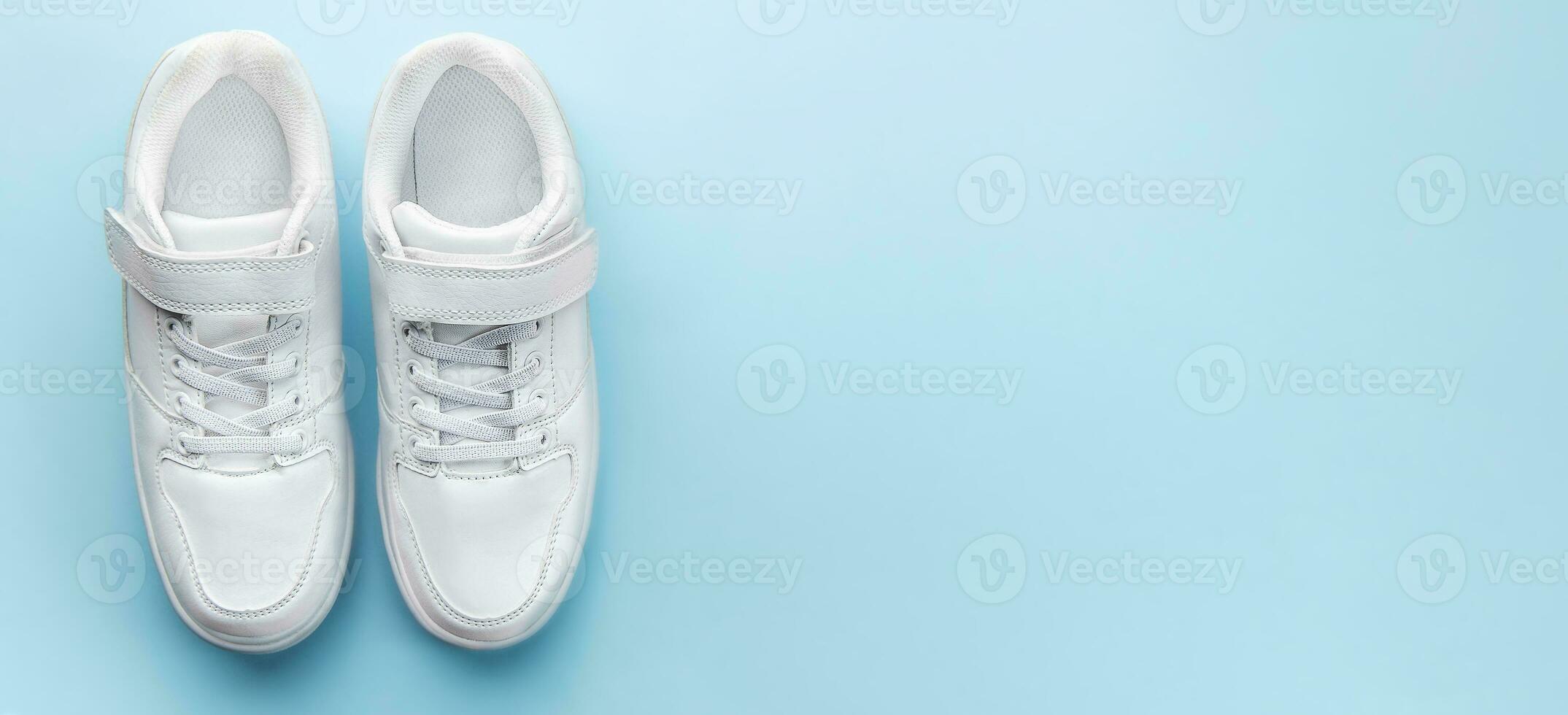 White sneakers on a blue background. photo