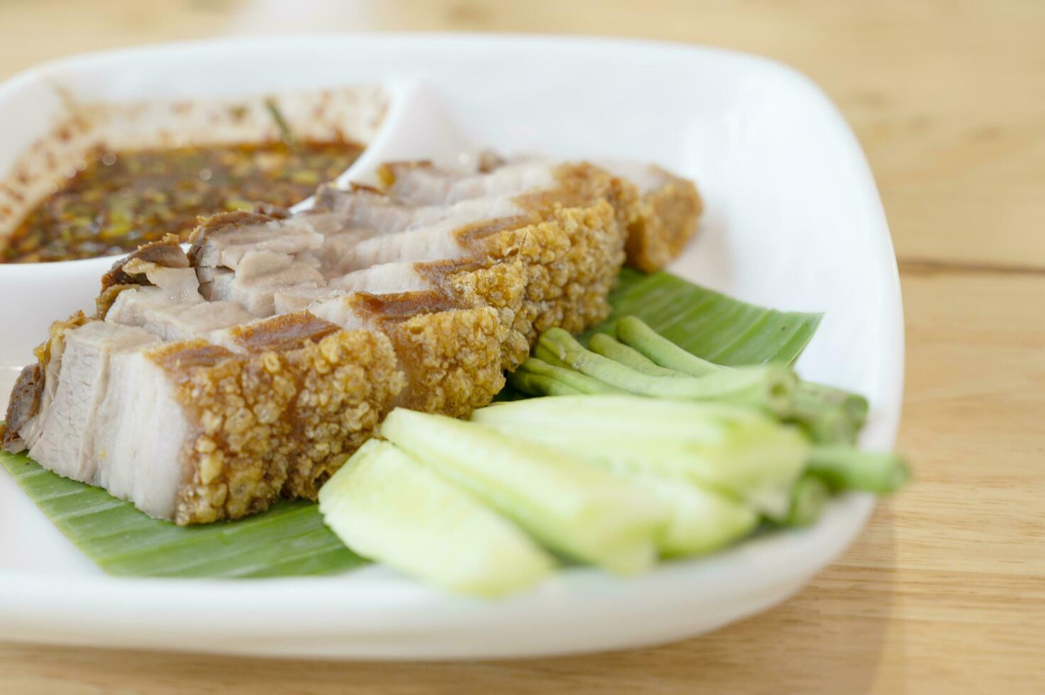 Crispy fried pork belly on a white plate photo