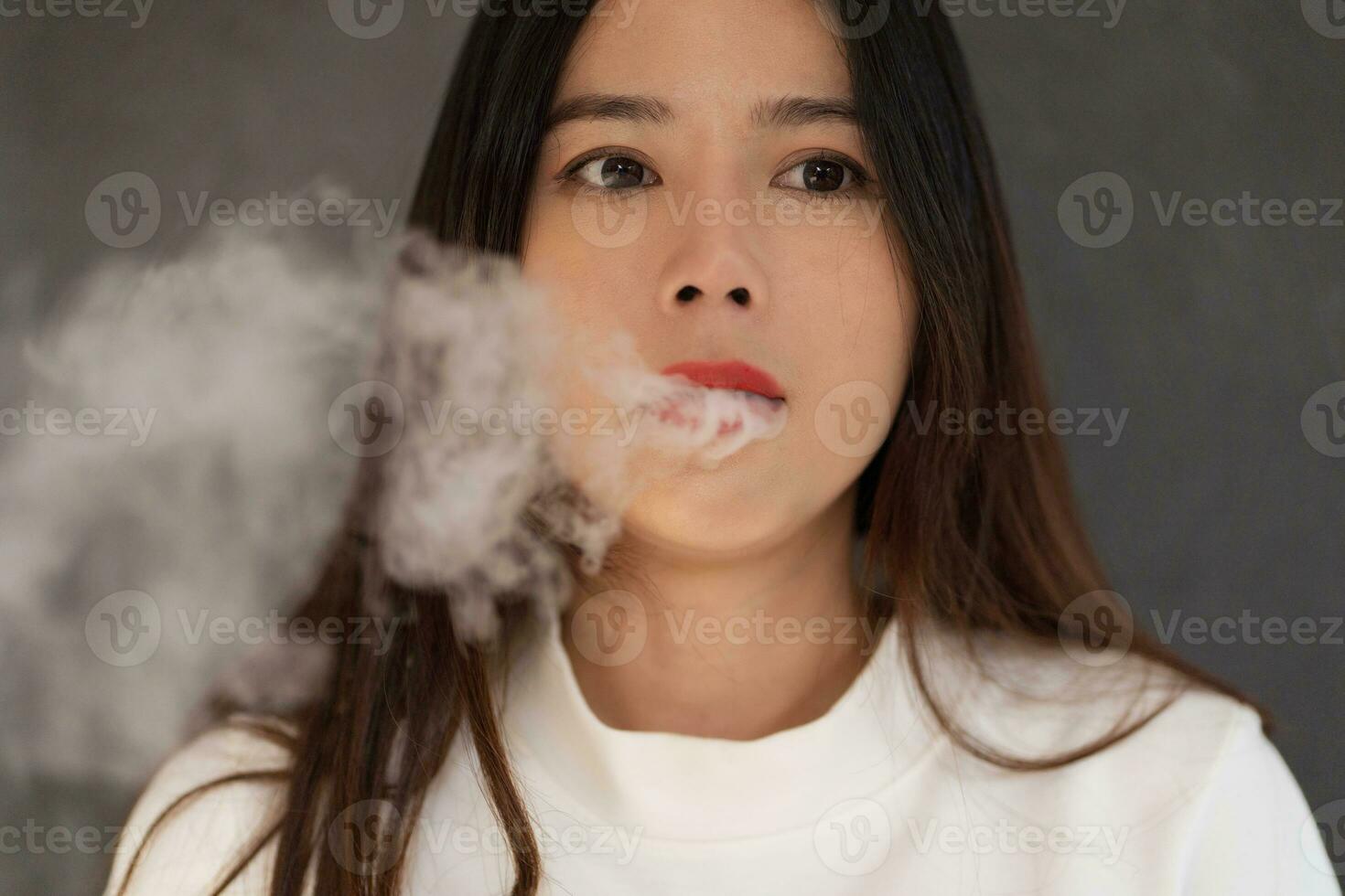 Asian woman smoking a cigarette, 31 May of World No Tobacco Day, photo
