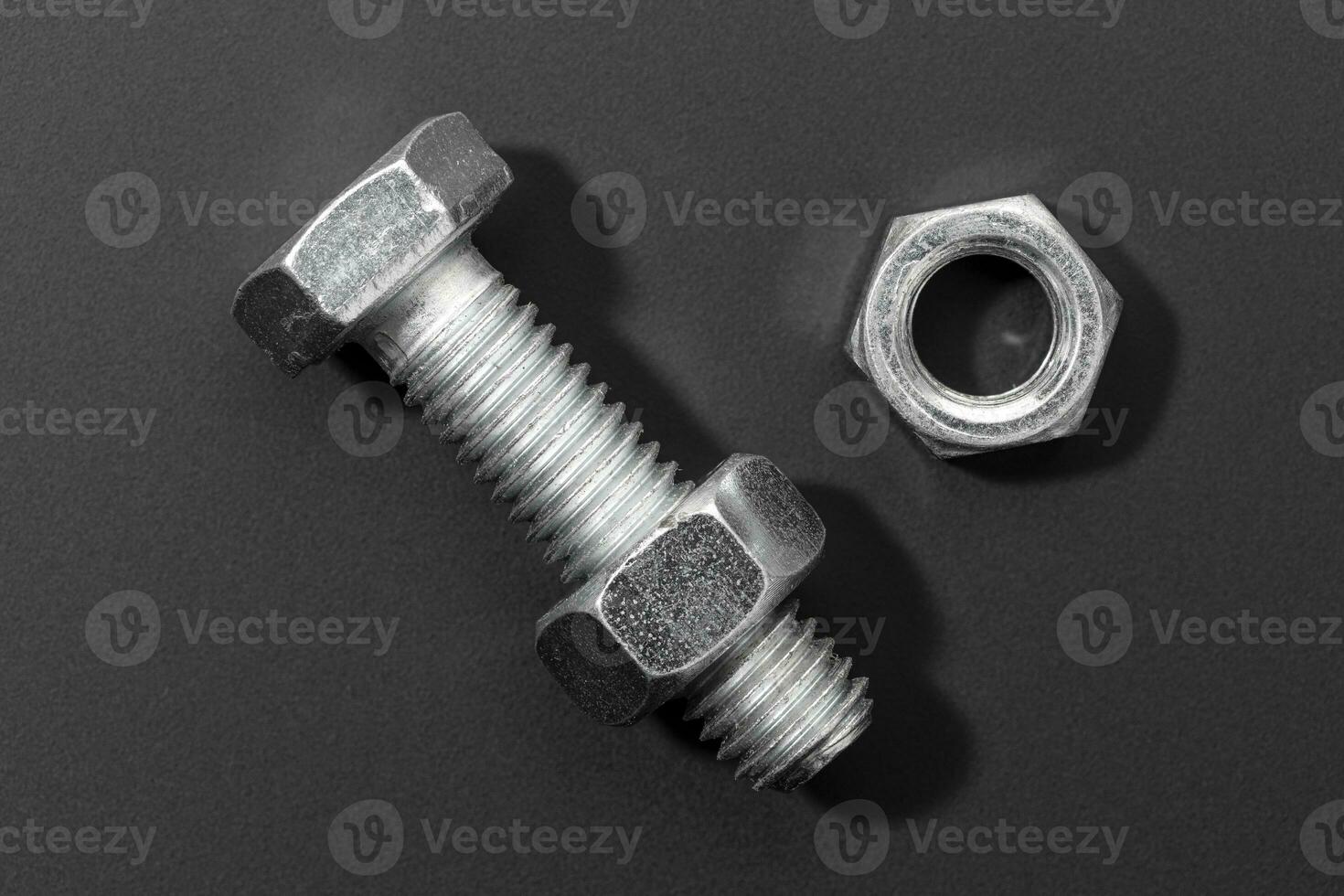 Bolt and nut isolated on black background photo