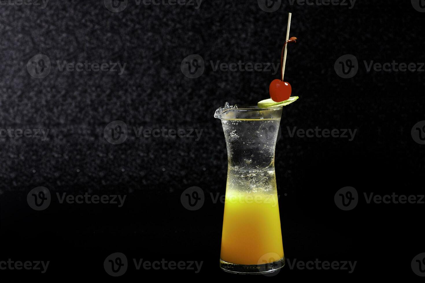 cocktail with lemon and cherry  on a black background photo