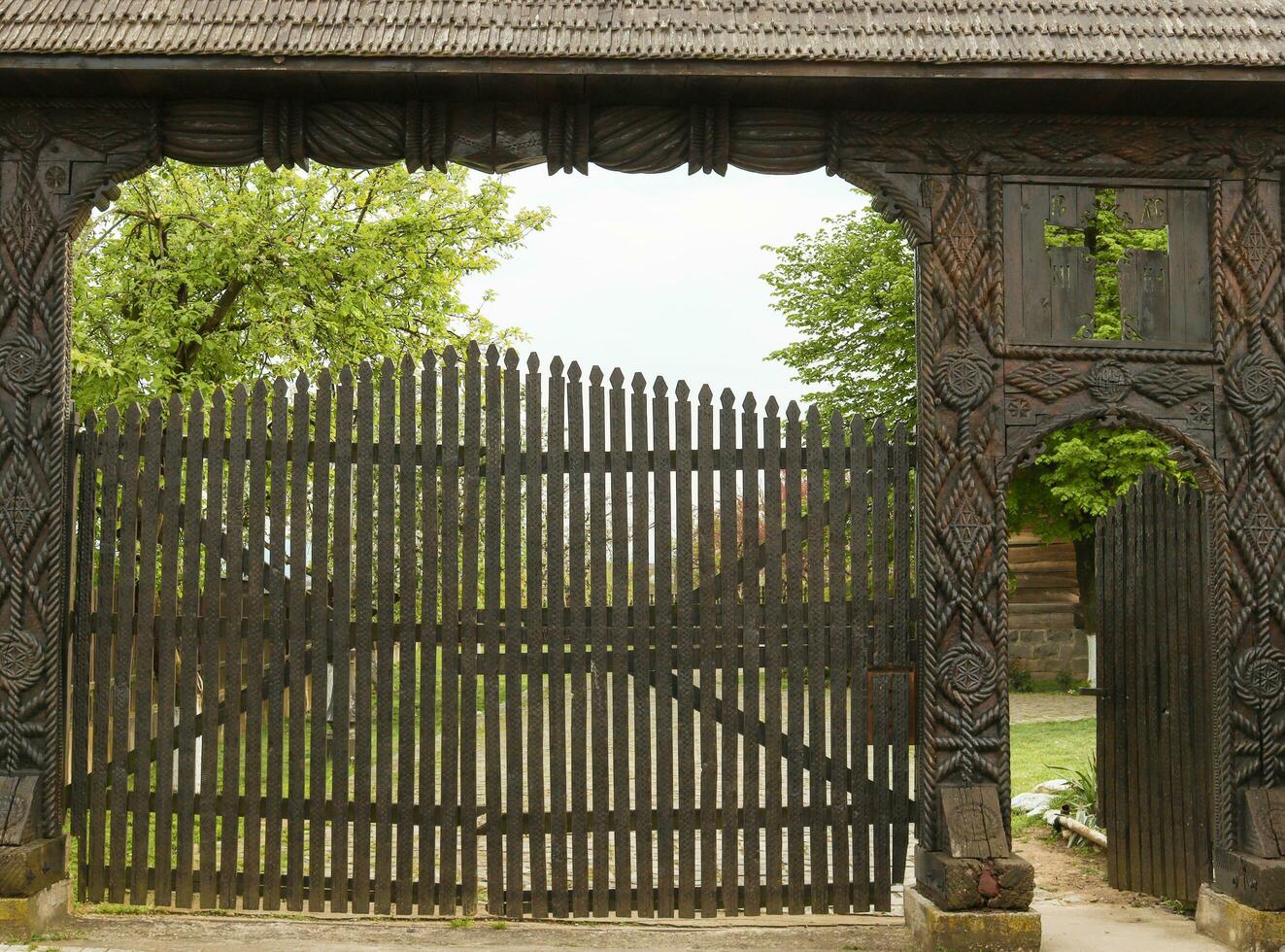 Old church gate made with dark oak wood in Alba Iulia , Romania photo