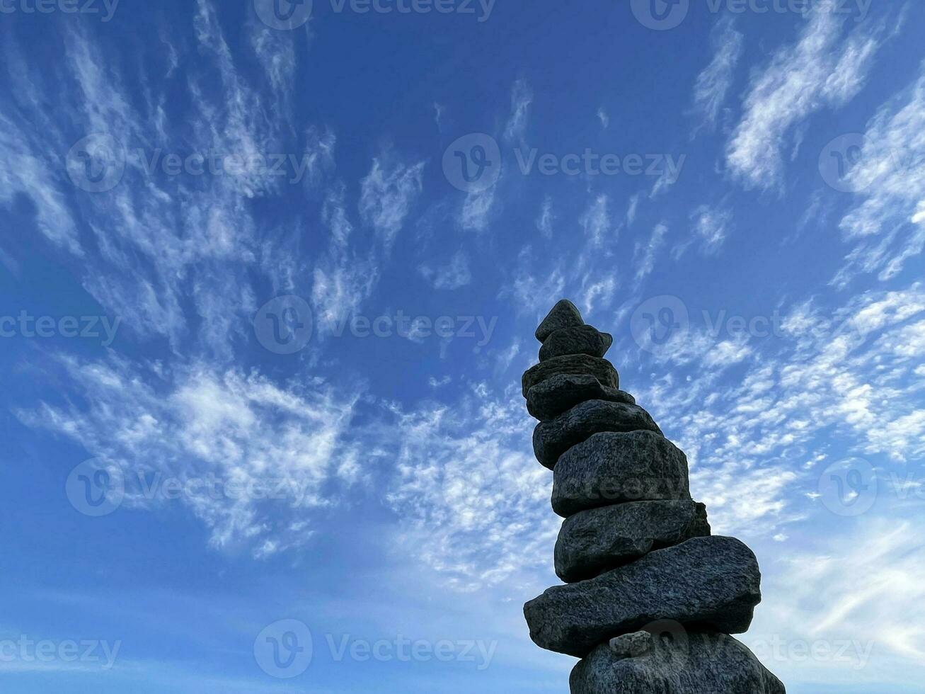 Pyramid of stones against the sky, the concept of balance. photo