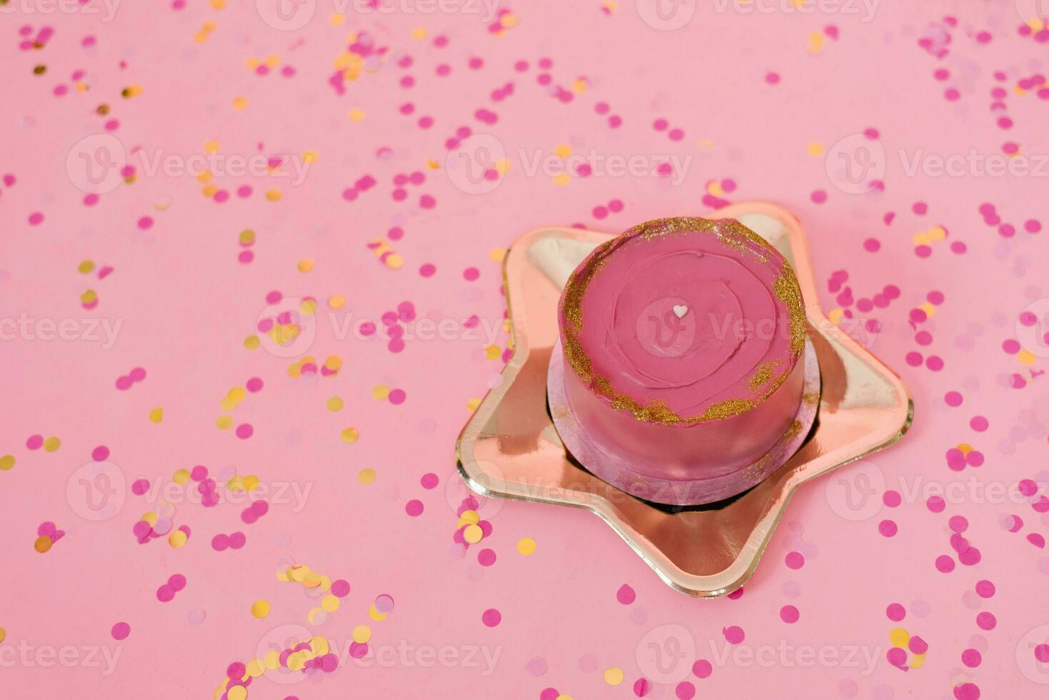 Trendy pink bento cake for Mom's day, birthday, Valentine's Day on a golden plate in the shape of a star on a pink background with confetti photo