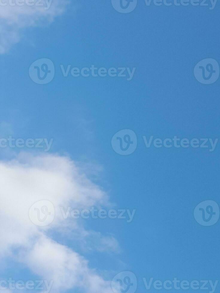 Beautiful white clouds on deep blue sky background. Large bright soft fluffy clouds are cover the entire blue sky. photo