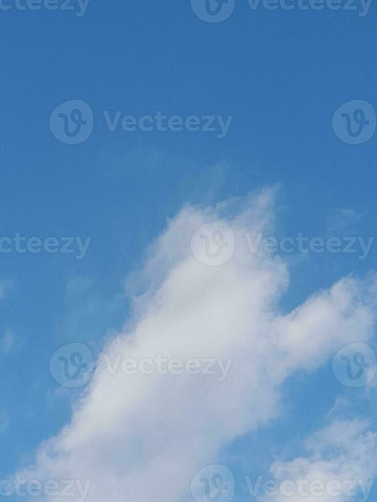 Beautiful white clouds on deep blue sky background. Large bright soft fluffy clouds are cover the entire blue sky. photo