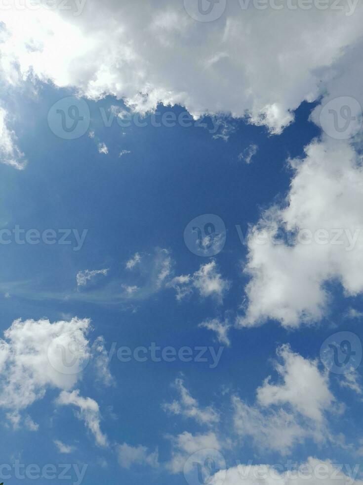 Beautiful white clouds on deep blue sky background. Large bright soft fluffy clouds are cover the entire blue sky. photo