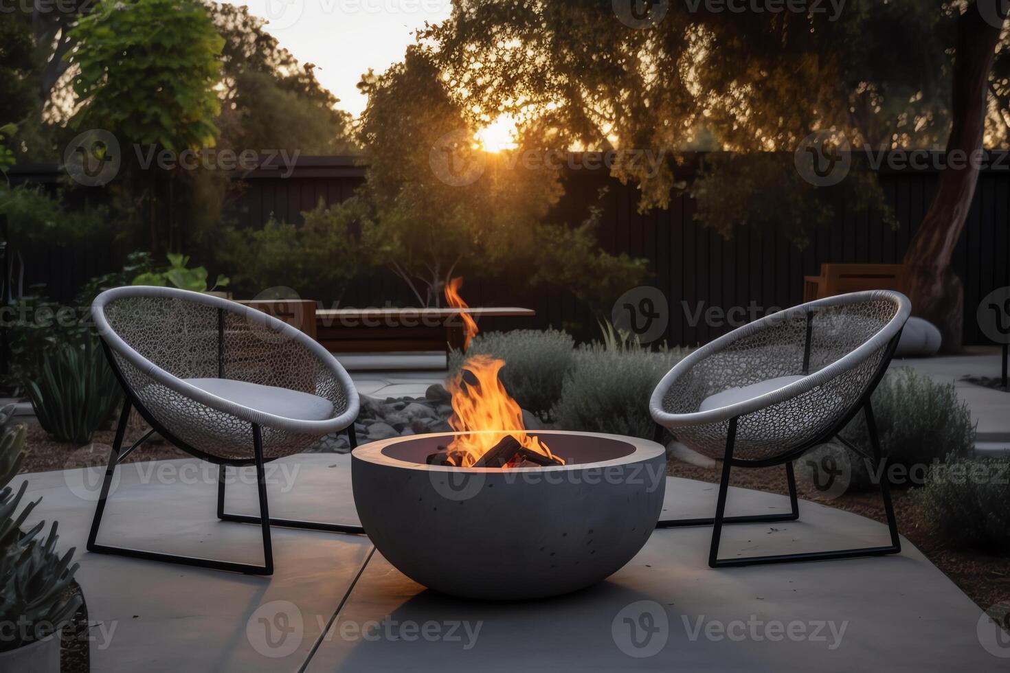 Outdoor backyard fire pit with grey modern furniture outdoor chairs seating on a sunset residential house terrace. photo