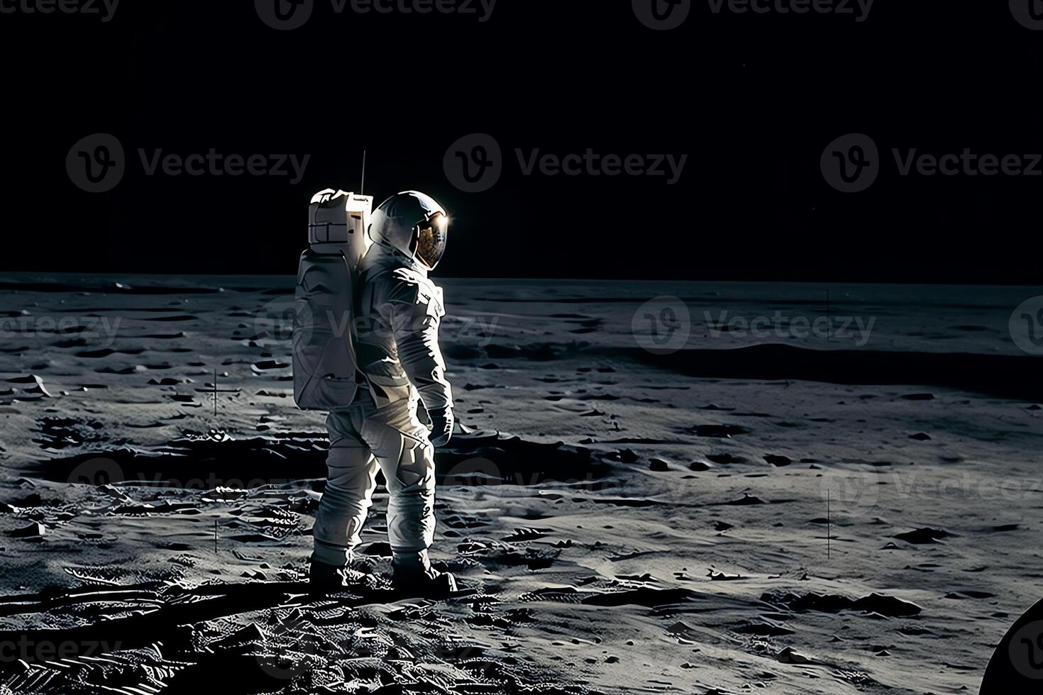 An astronaut standing on the moon looking at a large earth like planet. photo